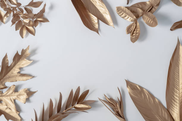 istock Gold tropical palm leaves Monstera on white background. Flat lay 1403075359