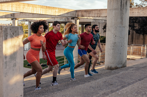 Healthy young multiracial people running race in the city
