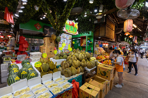 Hong Kong - June 15, 2022 : Shoppers at the Yau Ma Tei Fruit Market. It is a wholesale fruit market in Yau Ma Tei, Kowloon, Hong Kong. The market was founded in 1913.