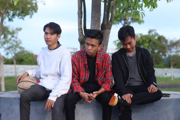 istock group men relaxing at city park 1403080256