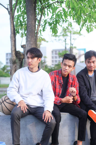 istock group men relaxing at city park 1403080394