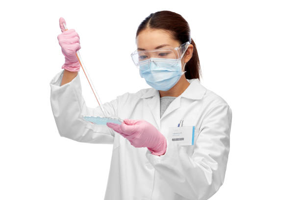 asian female scientist in mask working on vaccine stock photo