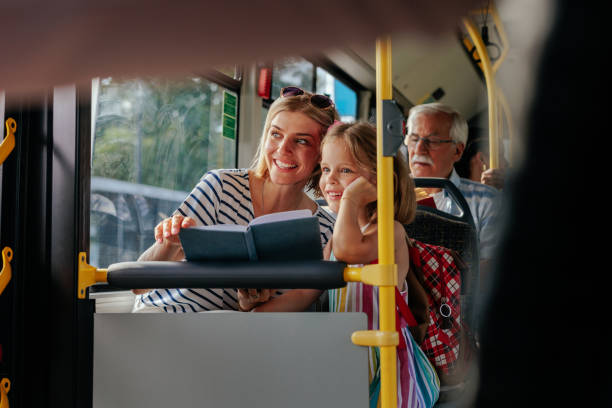 istock mom and daughter looking through bus window 1403080414