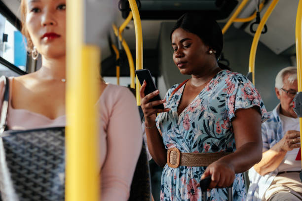 istock Black woman checking social media while riding shuttle bus 1403080448