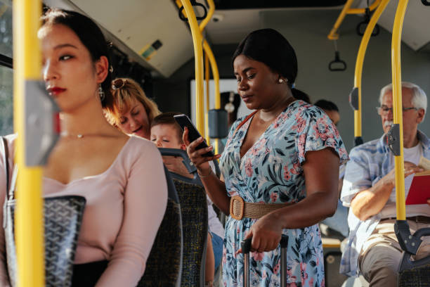 istock Black woman standing and texting in public transportation 1403080480