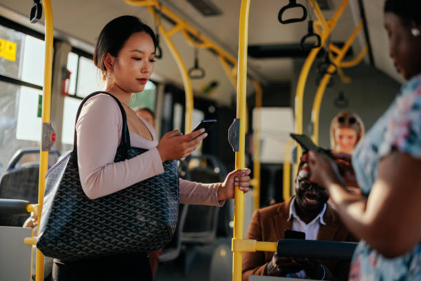 istock Young Asian woman texting in public transportation 1403080546