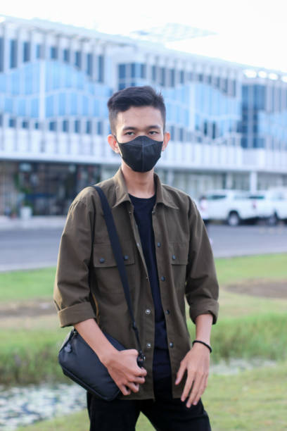 istock young man relaxing at city park with mask 1403080616
