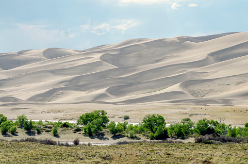 Great Sand Dunes National Park, Colorado, USA. Beautiful scenic majestic sand dunes and mountain peaks. Travel destination location for camping, hiking, relaxing and enjoying natures beautiful landscape.