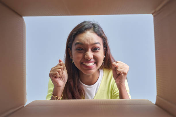istock Woman opening postal Package box in low angle view 1403080972