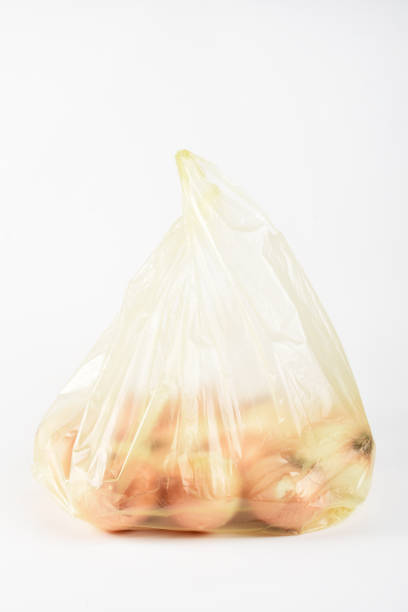 istock Onions in the plastic bag isolated on the white background 1403081822