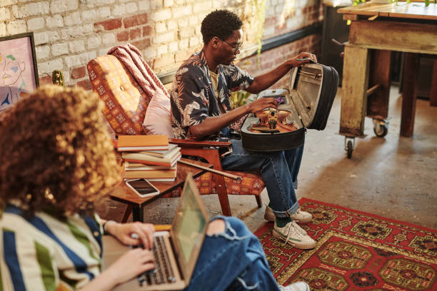 istock Young man opening case with violin while sitting in front of his girlfriend 1403082525