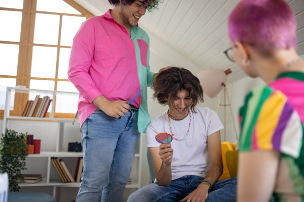 istock Caucasian male and female friends having fun while doing hairstyle 1403082744