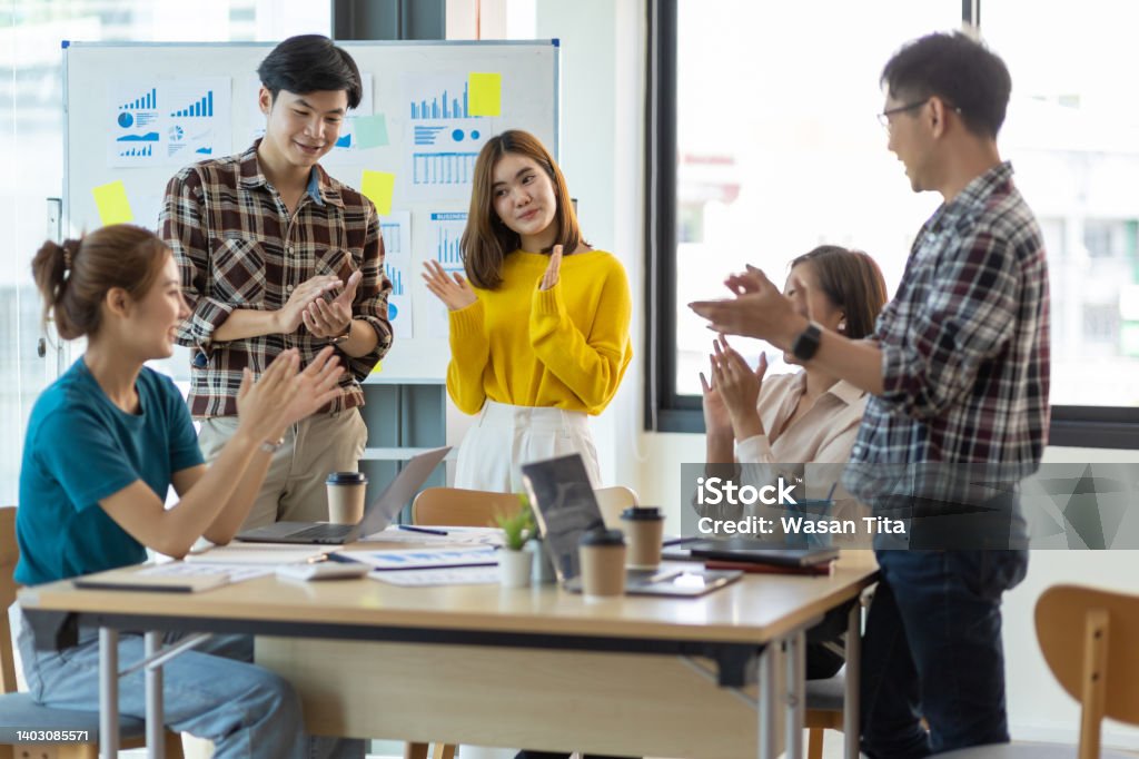 Young businessman team meeting clapping motivating colleagues. Occupation Stock Photo