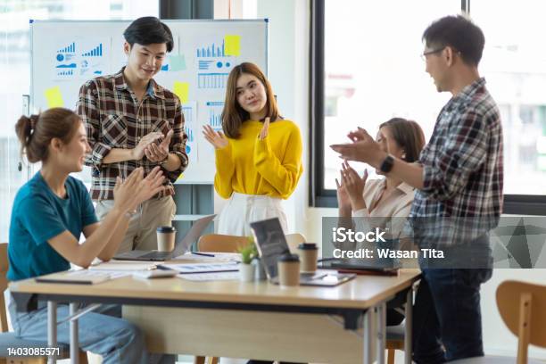 Young Businessman Team Meeting Clapping Motivating Colleagues Stock Photo - Download Image Now