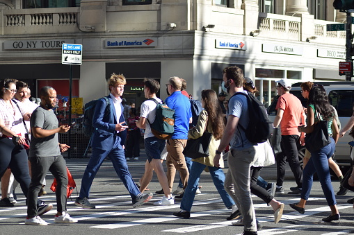 New York, NY USA - June 14, 2022: New York City, Pedestrians Walking and Crossing Streets During Evening Rush Hour in Midtown Manhattan