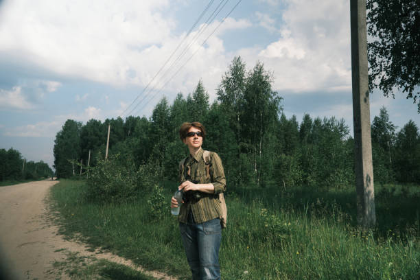 istock Birdwatcher is drinking water while walking through the village on extremely hot day 1403086140