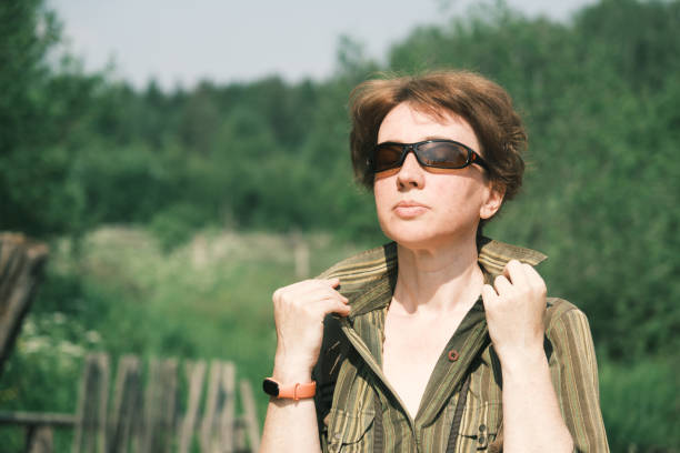 Birdwatcher is walking through the village on extremely hot day