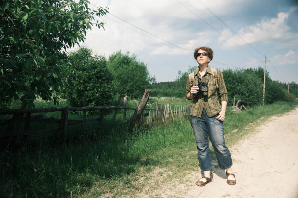 istock Birdwatcher is walking through the village on extremely hot day 1403086212