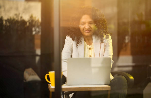 istock Businesswoman using laptop at cafe 1403087216