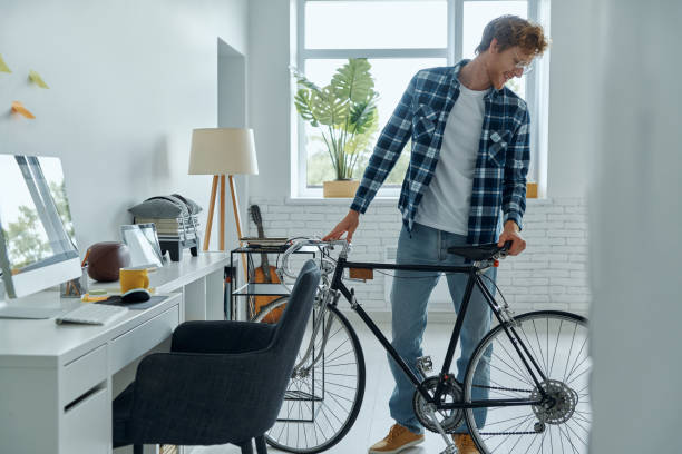 istock Confident young man examining his bicycle 1403087282