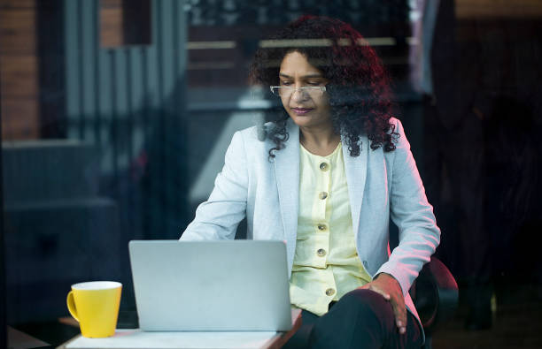 istock Businesswoman using laptop at cafe 1403087322
