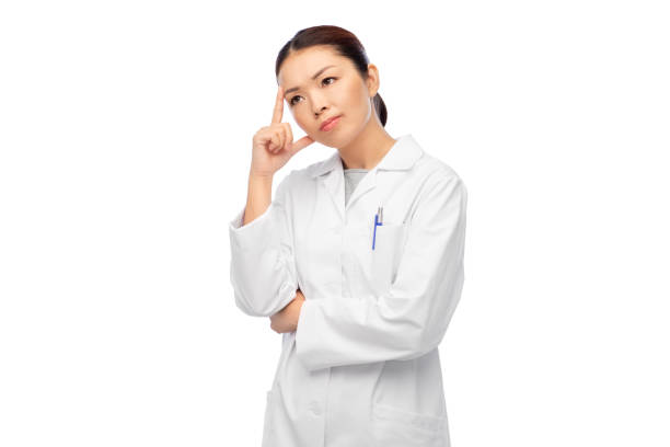 istock thinking asian female doctor in white coat 1403087548