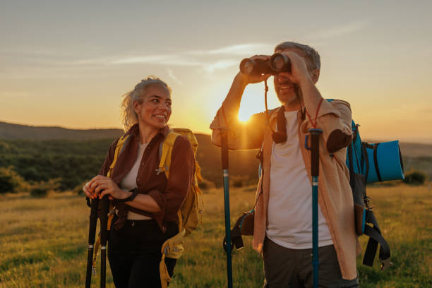 istock Couple with backpack hiking and admiring view in nature 1403087602