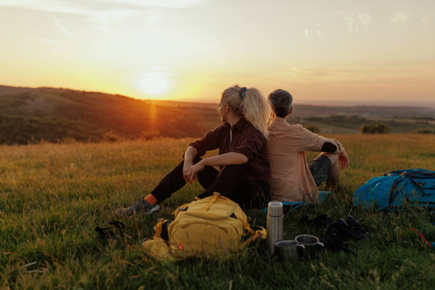 istock Couple of hikers resting on mountain 1403087639