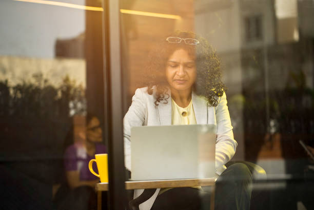 istock Businesswoman using laptop at cafe 1403088657