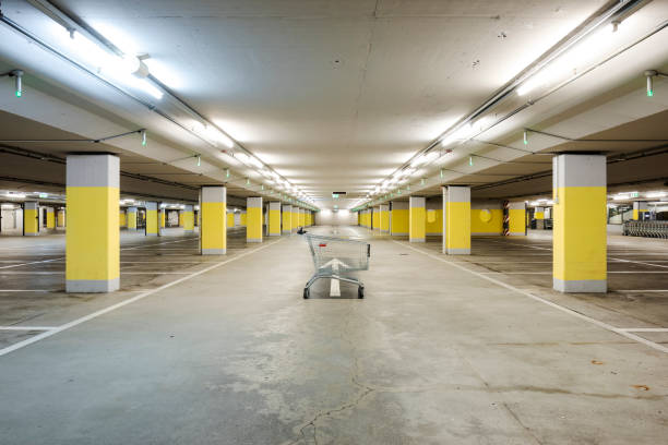 istock Front view empty underground supermarket parking with yellow concrete columns and white arrow on the ground 1403088972