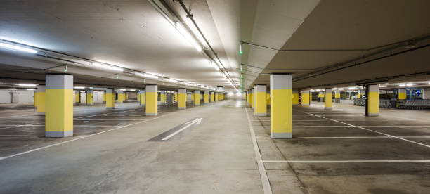 istock Front view empty underground supermarket parking with yellow concrete columns and white arrow on the ground 1403089014