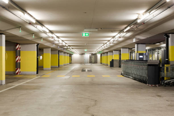 istock Front view empty underground supermarket parking with yellow concrete columns and white arrow on the ground 1403089068