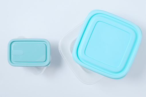 Two plastic container with a lid for food. White background.