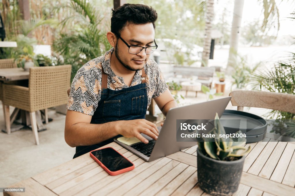 How to survive a recession: A guide for making the most of your money during a difficult time Young man at work Mexico Stock Photo