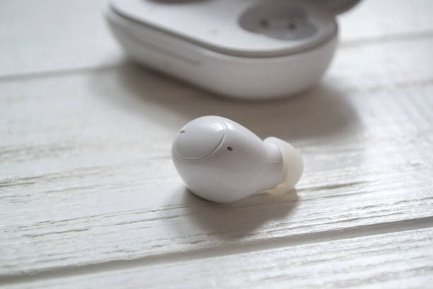 istock White wireless headphones on a wooden background. 1403090364