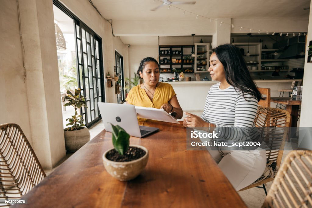 How to survive a recession: A guide for making the most of your money during a difficult time Employment during the recession - women  at work Laptop Stock Photo