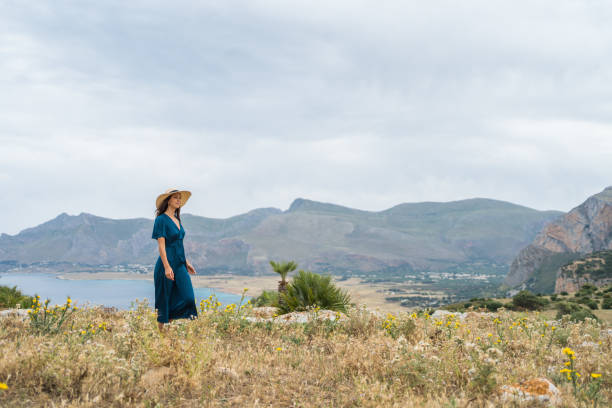 istock Young woman relaxes at coastal viewpoint 1403091901