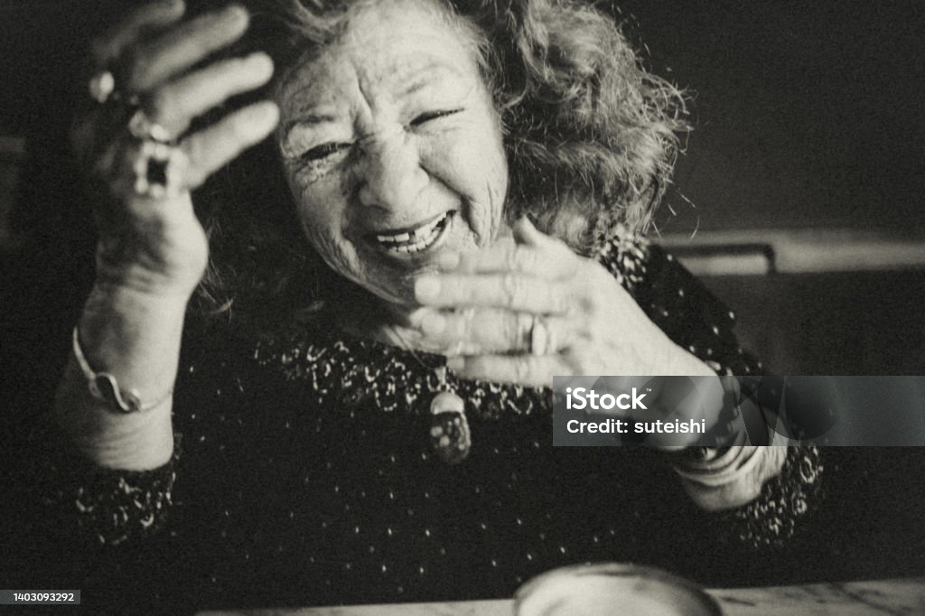 The hearty laugh of the elegant old lady. Portrait of an old lady. She laughs heartily to the viewer. She has a friendly and candid character. And a lot of fun! Reportage Stock Photo