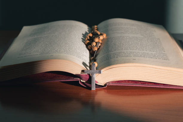 istock Cross on the holy bible on a wooden table 1403093322