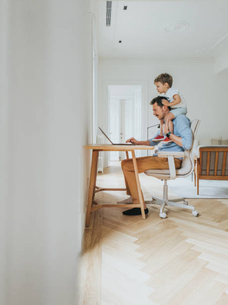 Father working at home while taking care of his