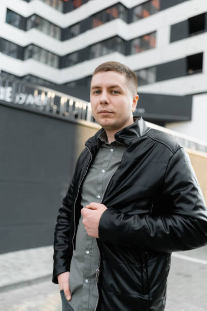 istock An attractive young man in a black leather jacket is looking at the camera 1403094619