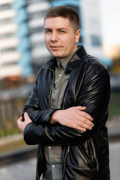 istock A handsome man is standing on the street smiling 1403094637