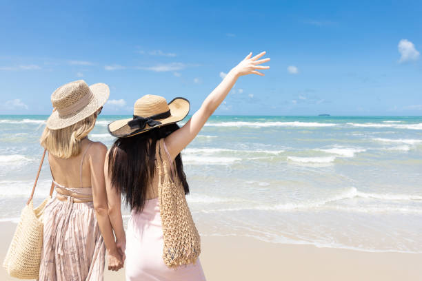istock back view women couple standing on the beach during summer vacation 1403094867