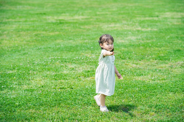 Asian girl playing on the lawn