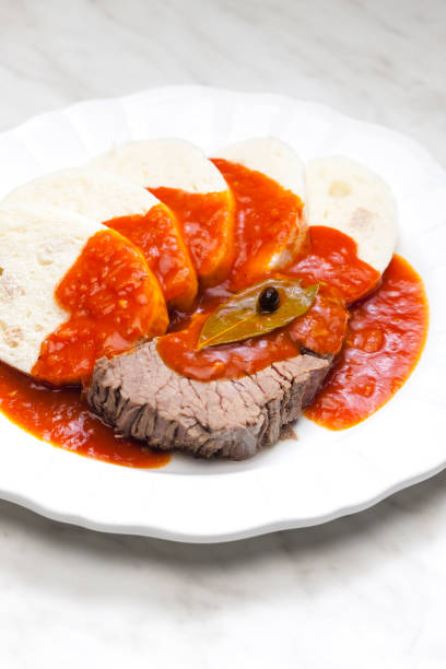 beef meat with tomato sauce and dumplings