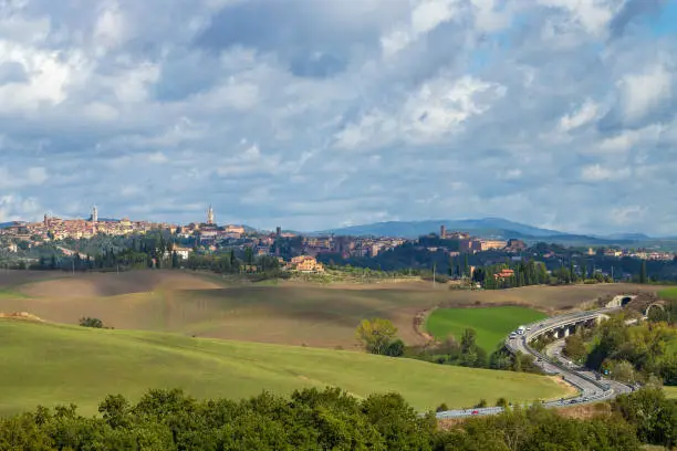 Photo of Typical Tuscan landscape withr Siena town, Tuscany, Italy