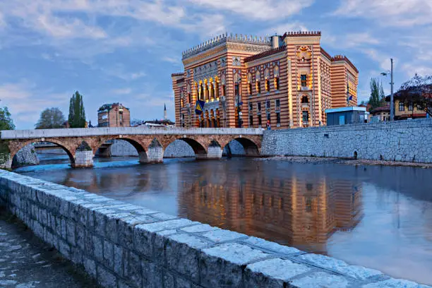 National and University library building which was former town hall with Ottoman arched bridge in Sarajevo, Bosnia and Herzegovina.