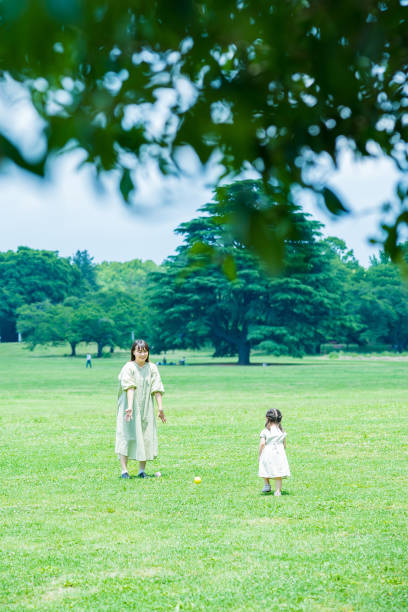 istock mother and her daughter playing in the park 1403097255