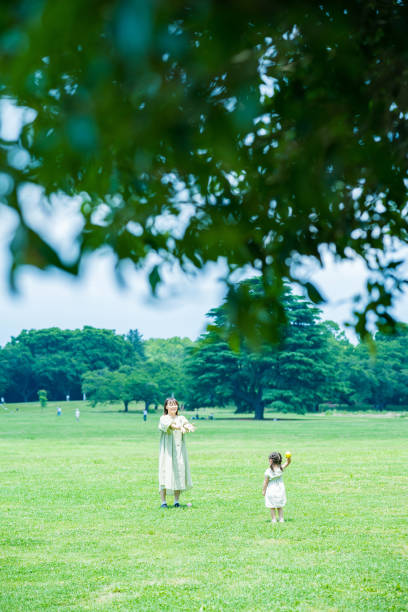 mother and her daughter playing in the park