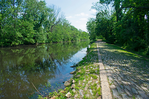 Footpath along the Delaware and Raritan Canal at Kingston, New Jersey. This section of the path is lined with flattened stones arranged in rows.